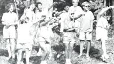 Students cheering at a Homecoming event. Photo from 1990 edition of The Drift