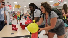 Li’Yonna McCallum (left) and Olivia Anton (right), freshman with the same first year seminar participate in a friendly competition at the late night Target event. Photo by Amy Street