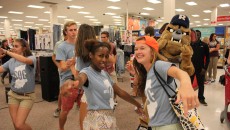 Laila Grayson (left) and Lindsey Gemmill (right) dance along with Hink and other student orientation guides. Photo by Amy Street
