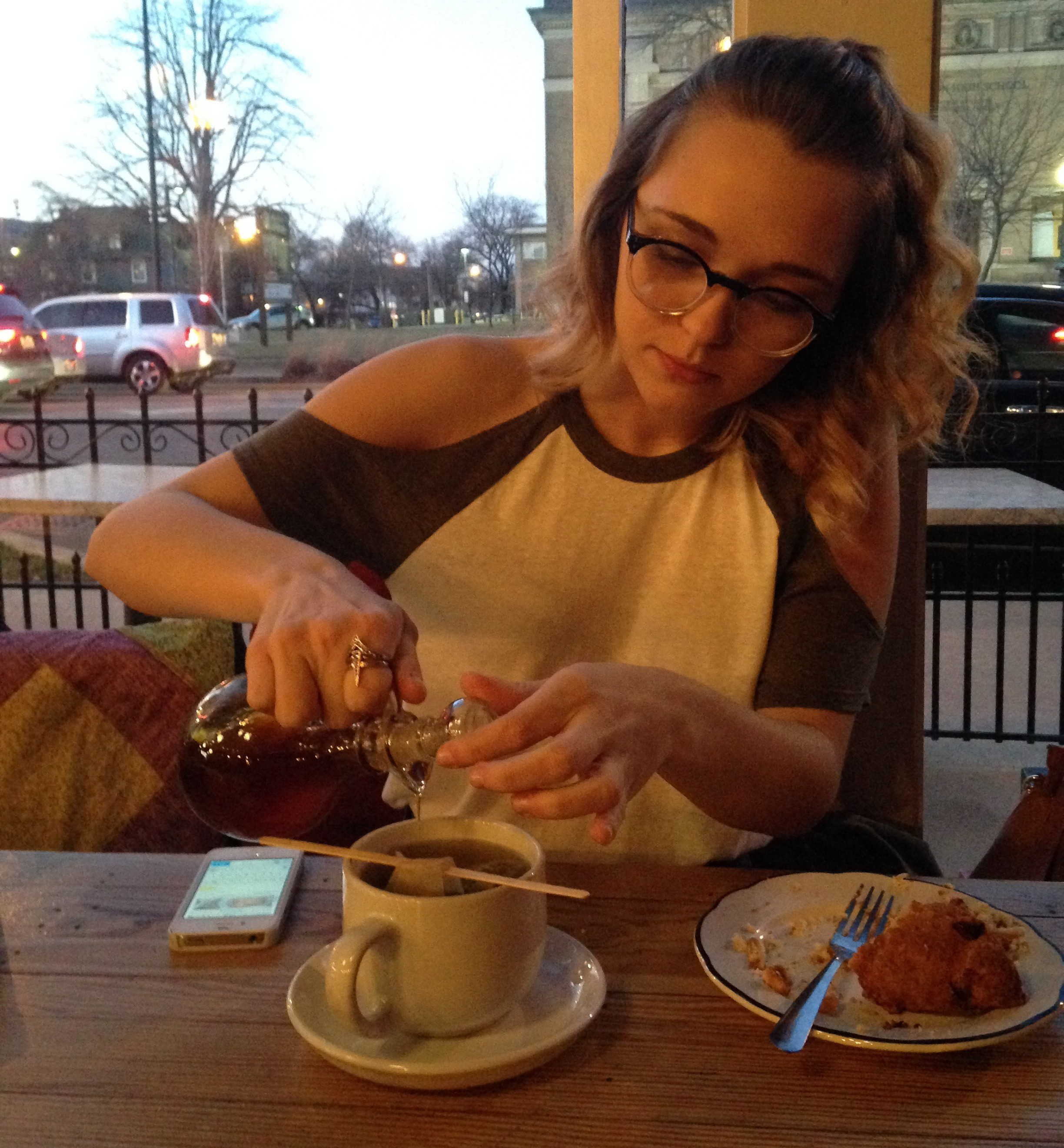 Price at the Thirsty Scholar pouring honey into her turmeric tonic. Photo courtesy of Caysi Johnson