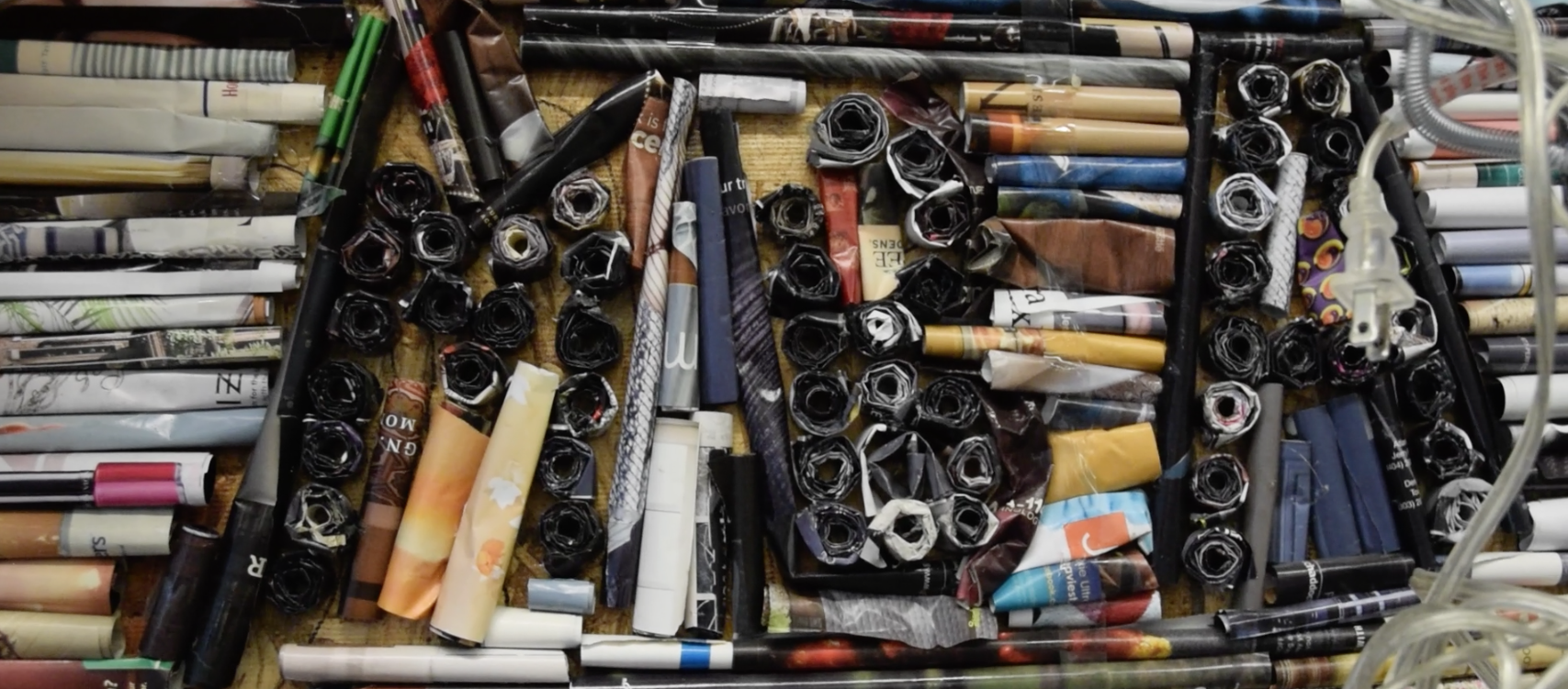 Students spell, "MBA" in the middle of a recycled magazine piece. - Photo by Alexis Price